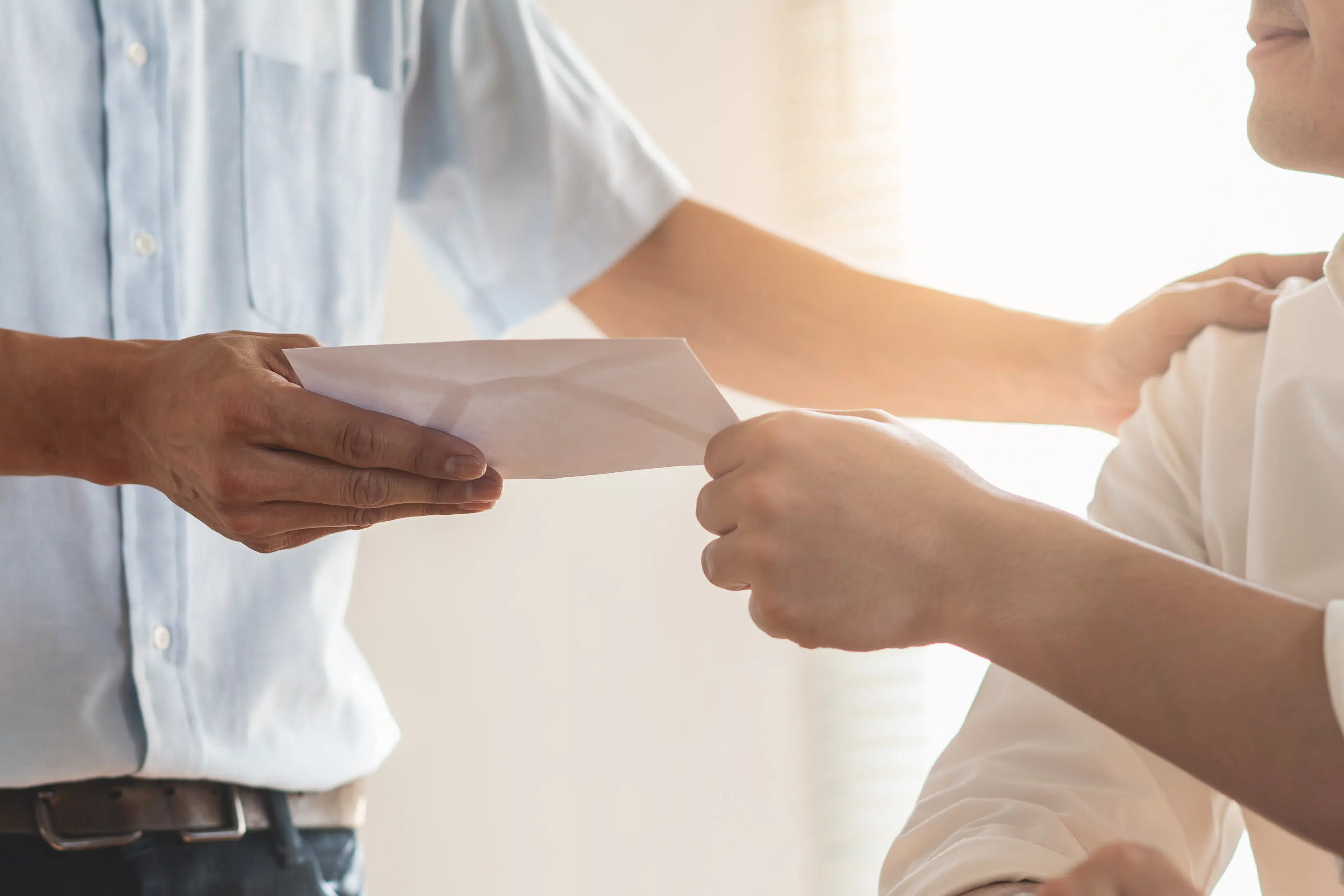 Close up view of office worker receiving salary from boss.